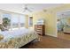 Comfortable main bedroom with a ceiling fan, sliding door, ocean view and wooden floors at 4631 S Atlantic Ave # 8102, Port Orange, FL 32127