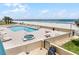 Overhead view of community pool, hot tub, beach and ocean at 4631 S Atlantic Ave # 8102, Port Orange, FL 32127