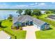 Aerial view of blue house, lake and private boat dock at 5005 Shore Side Dr, Lakeland, FL 33812