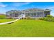Expansive backyard with lush lawn, leads to the lake, enhancing the serene waterfront property at 5005 Shore Side Dr, Lakeland, FL 33812