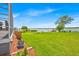 Beautifully landscaped backyard offers a tranquil lakeside setting with a lush green lawn at 5005 Shore Side Dr, Lakeland, FL 33812