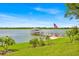 Lakeside home with a private dock, seating, and American flag surrounded by a well-manicured lawn and landscaping at 5005 Shore Side Dr, Lakeland, FL 33812