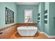 Luxurious bathroom with freestanding tub, tiled accent wall, and natural light at 5005 Shore Side Dr, Lakeland, FL 33812
