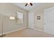 A bright, neutral bedroom features a window and trim. A ceiling fan is installed at 5005 Shore Side Dr, Lakeland, FL 33812