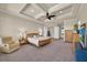 Large bedroom featuring a coffered ceiling, ceiling fan, and sitting area at 5005 Shore Side Dr, Lakeland, FL 33812