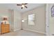 Cozy bedroom with neutral walls, a ceiling fan, and a window providing ample natural light at 5005 Shore Side Dr, Lakeland, FL 33812