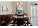 Inviting dining room with wooden table, decorative chandelier, and shuttered window at 5005 Shore Side Dr, Lakeland, FL 33812