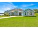 Charming exterior of a beautiful home with lush green lawn and well-manicured landscaping at 5005 Shore Side Dr, Lakeland, FL 33812