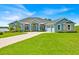 Beautiful home with a well-manicured lawn and a circular driveway at 5005 Shore Side Dr, Lakeland, FL 33812