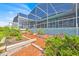 Landscaped gardens enhance the backyard with raised beds and manicured plants adding natural beauty at 5005 Shore Side Dr, Lakeland, FL 33812
