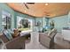 Stylish sunroom featuring waterfront views, comfortable seating, and a wood ceiling at 5005 Shore Side Dr, Lakeland, FL 33812