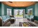 Stylish sunroom featuring waterfront views, comfortable seating, and a wood ceiling at 5005 Shore Side Dr, Lakeland, FL 33812
