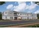 Long shot of townhomes with various colored siding, stone accents, garages and front doors at 5087 Prairie Preserve Run, St Cloud, FL 34772