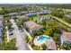 Aerial view showcasing the community, pool, pond, parking, and well-maintained landscaping at 517 Wilton Cir, Sanford, FL 32773