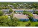 Community featuring blue townhomes, mature trees, ample parking, and inviting swimming pool at 517 Wilton Cir, Sanford, FL 32773