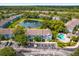 Aerial view showcasing the community, pool, pond, parking, and well-maintained landscaping at 517 Wilton Cir, Sanford, FL 32773