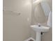Half bathroom featuring a pedestal sink and a round mirror at 517 Wilton Cir, Sanford, FL 32773