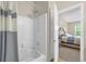 Inviting bathroom featuring a tub with shower and neutral tile surround at 517 Wilton Cir, Sanford, FL 32773