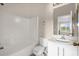 Bright bathroom featuring a shower-tub combo, white vanity, and neutral walls at 517 Wilton Cir, Sanford, FL 32773