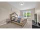 Comfortable bedroom with carpeted floors and a large window providing natural light at 517 Wilton Cir, Sanford, FL 32773