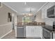 Beautiful kitchen featuring granite countertops, stainless steel appliances, and an open layout to the living area at 517 Wilton Cir, Sanford, FL 32773