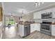 Modern kitchen with stainless steel appliances and granite countertops with an open view to the living room at 517 Wilton Cir, Sanford, FL 32773