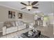 Cozy living room showcasing open layout to kitchen with tile floors and neutral paint at 517 Wilton Cir, Sanford, FL 32773