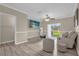 Bright living room featuring wood-look tile floors and sliding glass doors to the outside at 517 Wilton Cir, Sanford, FL 32773