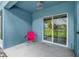 Outdoor patio with a red lawn chair overlooking the community lawn at 517 Wilton Cir, Sanford, FL 32773