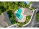Aerial view of a community pool surrounded by lush landscaping and seating areas at 517 Wilton Cir, Sanford, FL 32773