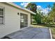 Back patio with concrete pavers and a sliding glass door to access the home's interior at 5210 Poinsetta Ave, Winter Park, FL 32792