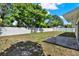 This photo showcases a spacious backyard featuring a well-maintained lawn, mature trees, and a patio area at 5210 Poinsetta Ave, Winter Park, FL 32792