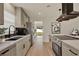 Modern kitchen with stainless steel appliances, sleek cabinetry, and stylish black hardware at 5210 Poinsetta Ave, Winter Park, FL 32792