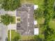 Aerial view of the roof, lawn, and driveway with the road and neighboring homes in the background at 533 Mount Olympus Blvd, New Smyrna Beach, FL 32168