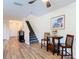 Bright entryway featuring a staircase, laminate flooring, and coastal-themed art at 533 Mount Olympus Blvd, New Smyrna Beach, FL 32168