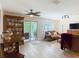 Inviting living room with a ceiling fan, dining table, and sliding glass doors to the outside at 533 Mount Olympus Blvd, New Smyrna Beach, FL 32168