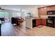 Open concept view of kitchen and living room area showing laminate flooring and sliding glass door at 533 Mount Olympus Blvd, New Smyrna Beach, FL 32168