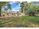Backyard with lush greenery and beautiful trees at 5460 Se 28Th St, Ocala, FL 34480