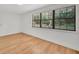 Bright bedroom with wood-look floors and a large window offers serene natural light at 5460 Se 28Th St, Ocala, FL 34480