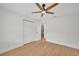 This bedroom features wood-look floors, a ceiling fan, and a closet at 5460 Se 28Th St, Ocala, FL 34480