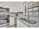 Kitchen showcasing stainless steel appliances, granite countertops, and white cabinetry at 5460 Se 28Th St, Ocala, FL 34480