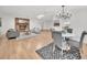 Bright living room featuring a brick fireplace, modern decor, and wood laminate flooring at 5460 Se 28Th St, Ocala, FL 34480