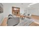 Bright living room featuring a brick fireplace, modern decor, and wood laminate flooring at 5460 Se 28Th St, Ocala, FL 34480