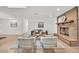 Bright living room featuring a brick fireplace, modern decor, and wood laminate flooring at 5460 Se 28Th St, Ocala, FL 34480