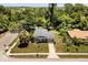 Aerial view of a charming home featuring manicured lawn, mature trees, and a welcoming walkway at 600 Plum Ln, Altamonte Springs, FL 32701
