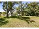 Spacious backyard featuring mature trees, grass, and home at 600 Plum Ln, Altamonte Springs, FL 32701