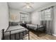 Cozy bedroom features twin beds, ceiling fan, and plenty of natural light from the window at 600 Plum Ln, Altamonte Springs, FL 32701