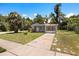 Single-story home featuring gray stucco, a well-kept lawn, and mature trees at 600 Plum Ln, Altamonte Springs, FL 32701
