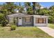 Charming single-story home with a well-maintained front yard and gray painted stucco at 600 Plum Ln, Altamonte Springs, FL 32701