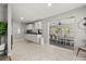 Open kitchen with white cabinets that flows into the dining area at 600 Plum Ln, Altamonte Springs, FL 32701